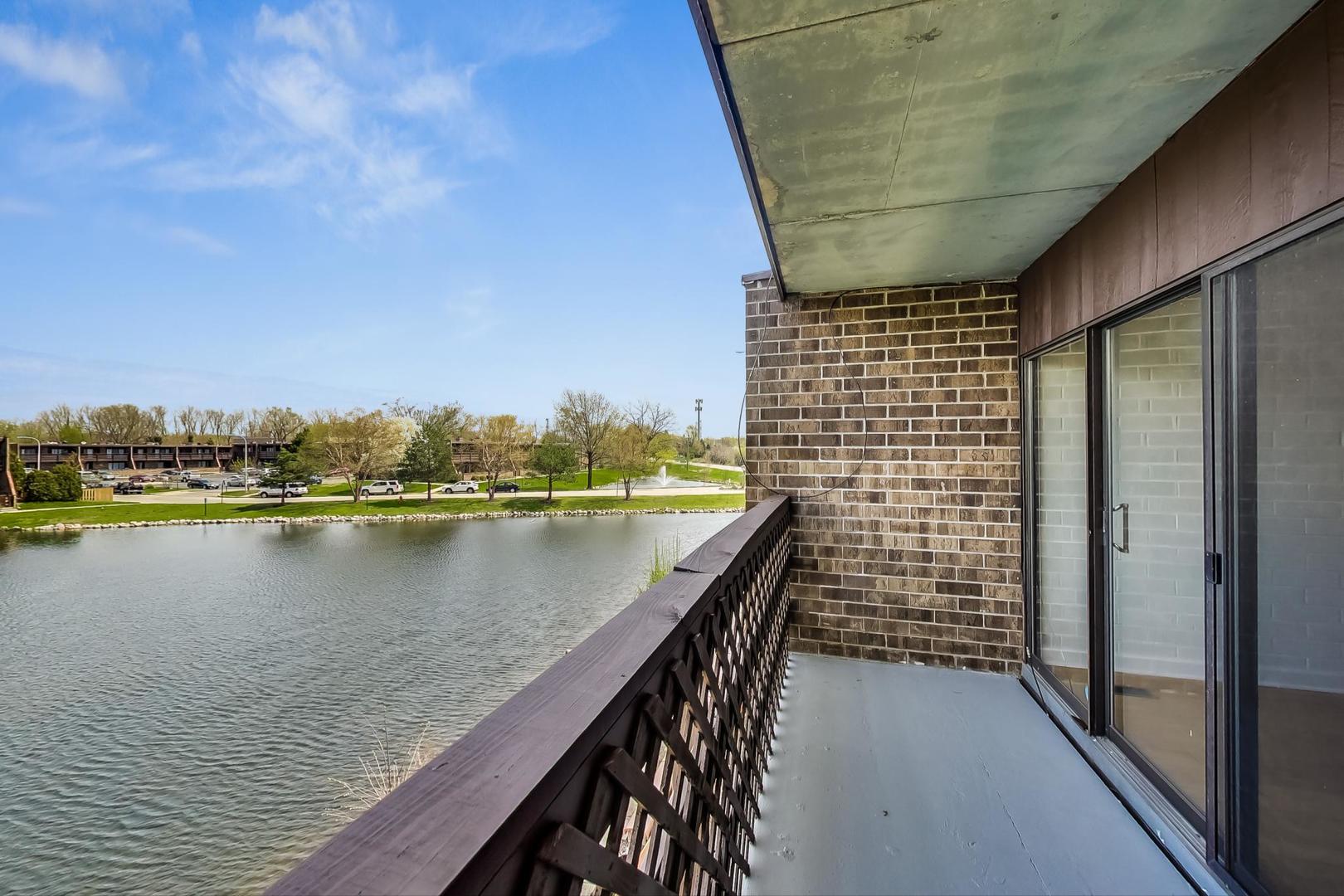 102 Kenneth Circle Elgin, IL 60120 - Photo 19 of 33 a view of swimming pool with lake and houses in the back