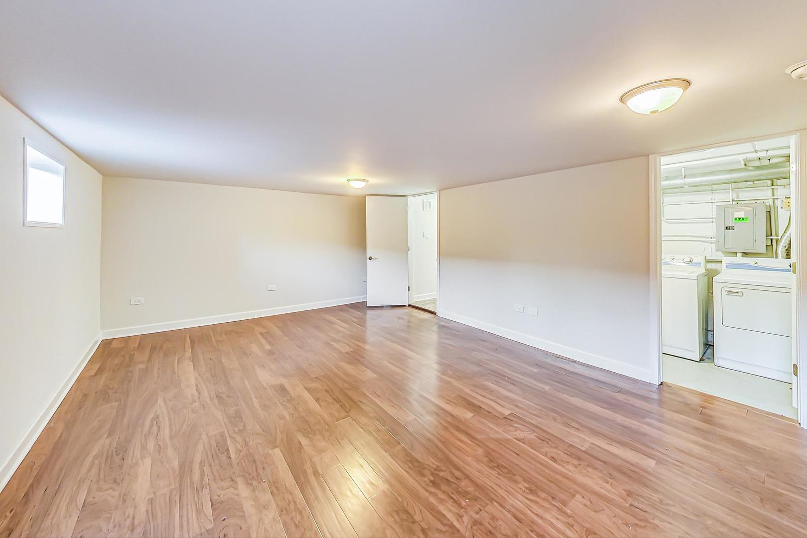 102 Kenneth Circle Elgin, IL 60120 - Photo 22 of 33 wooden floor in an empty room with a window