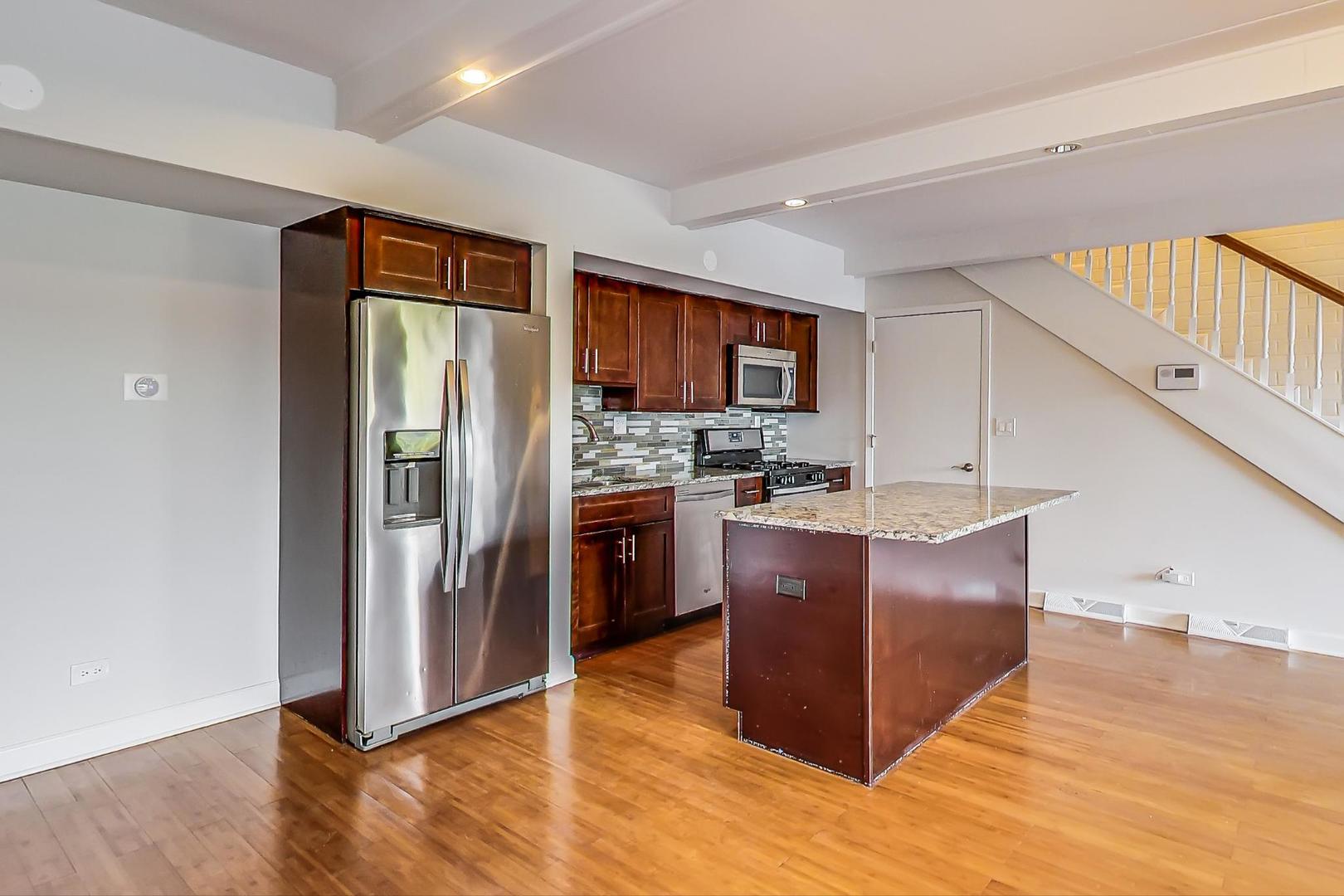 102 Kenneth Circle Elgin, IL 60120 - Photo 7 of 33 a kitchen with stainless steel appliances granite countertop a refrigerator and a stove