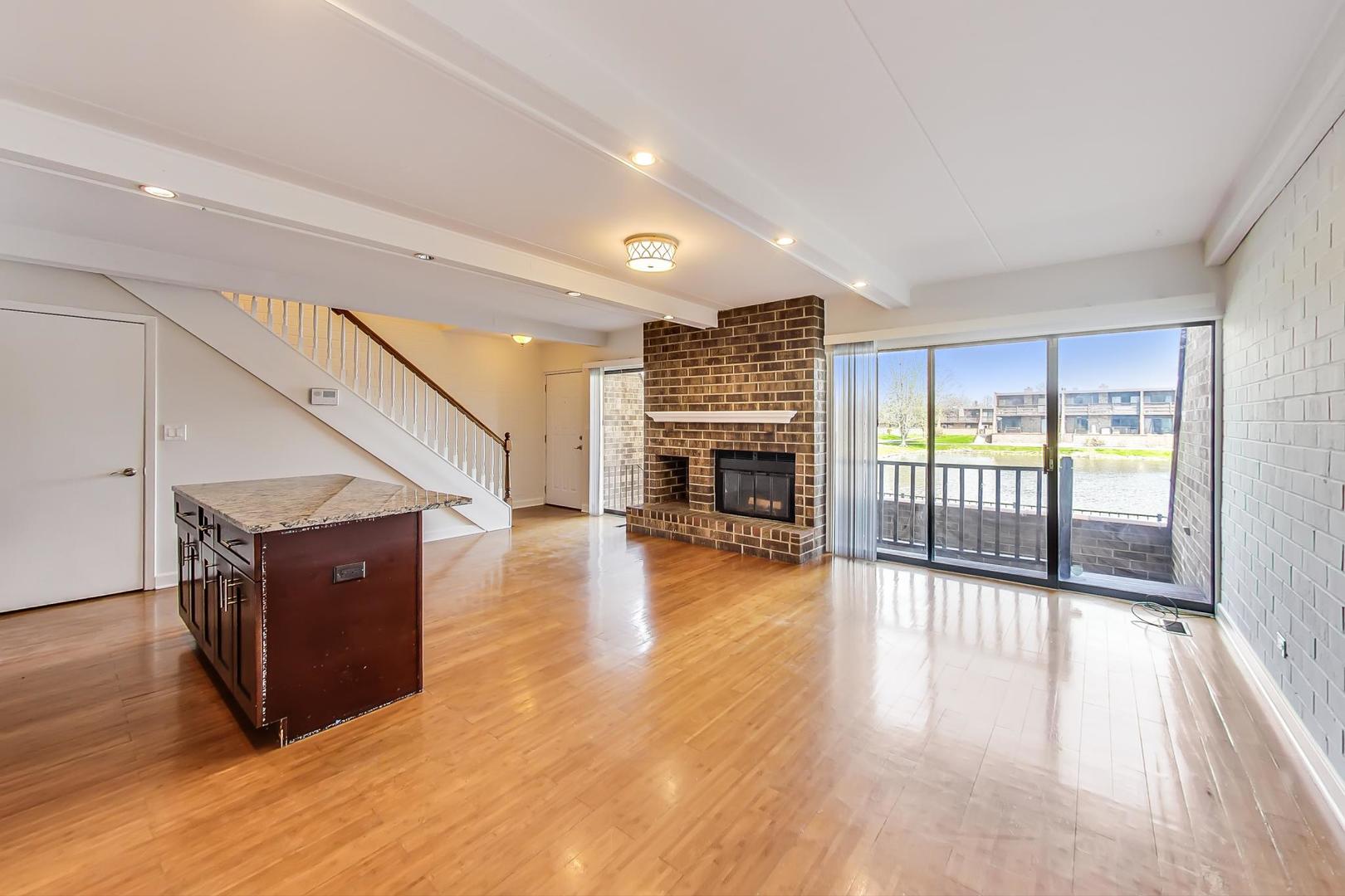 102 Kenneth Circle Elgin, IL 60120 - Photo 8 of 33 a view of a livingroom with wooden floor and a fireplace