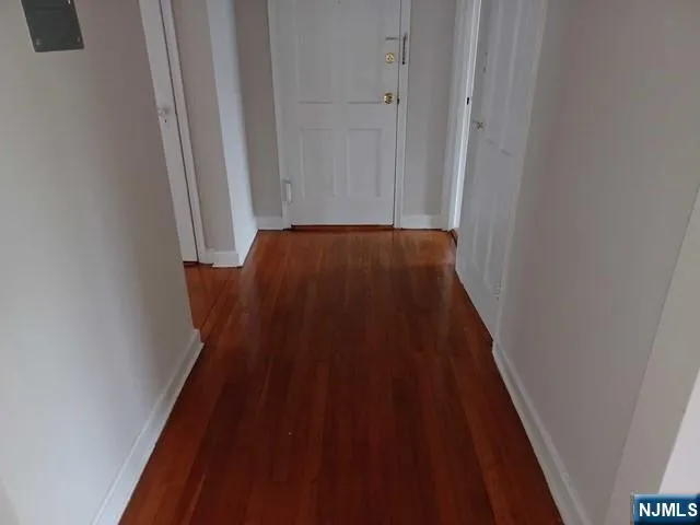 a view of a hallway with wooden floor