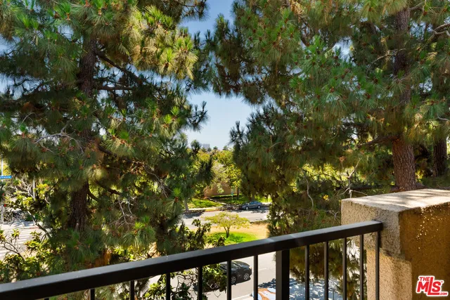 a view of a balcony with a tree