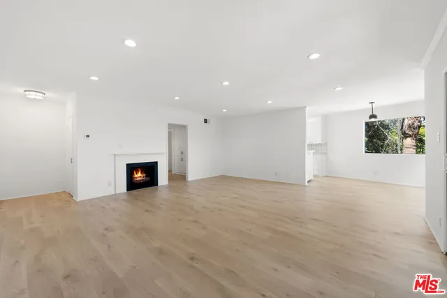 a view of an empty room with a fireplace