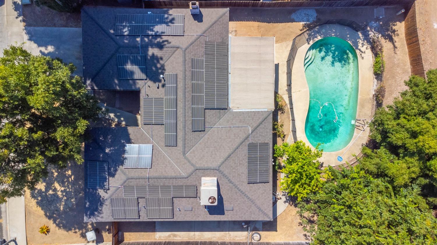 an aerial view of a residential houses with yard