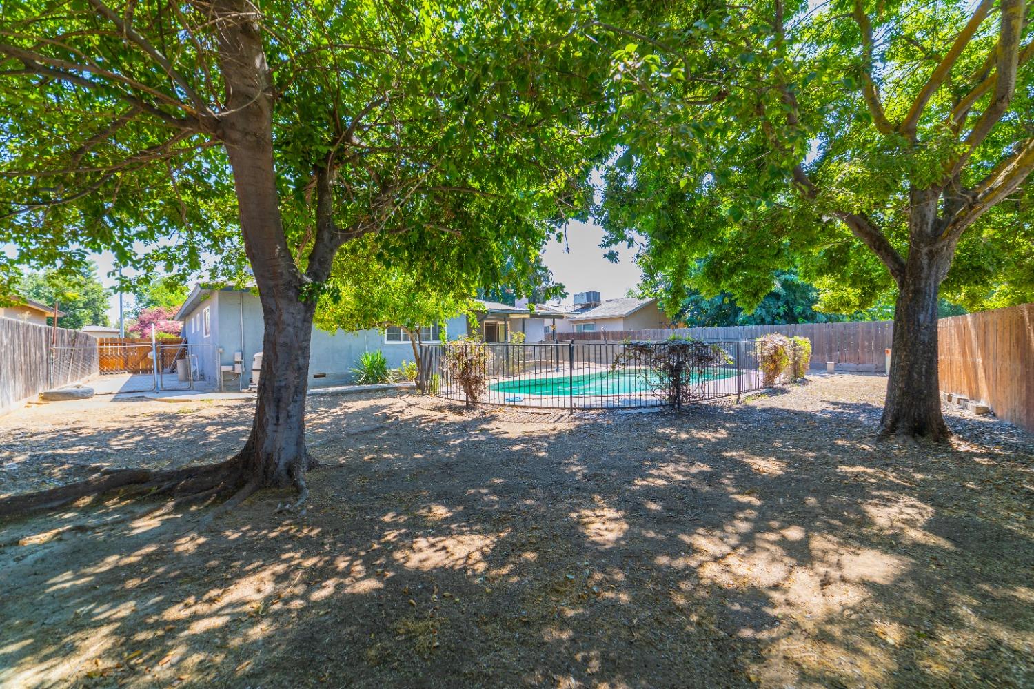 142 West Swift Avenue Clovis, CA 93612 - Photo 15 of 24 a view of a tree in front of a house