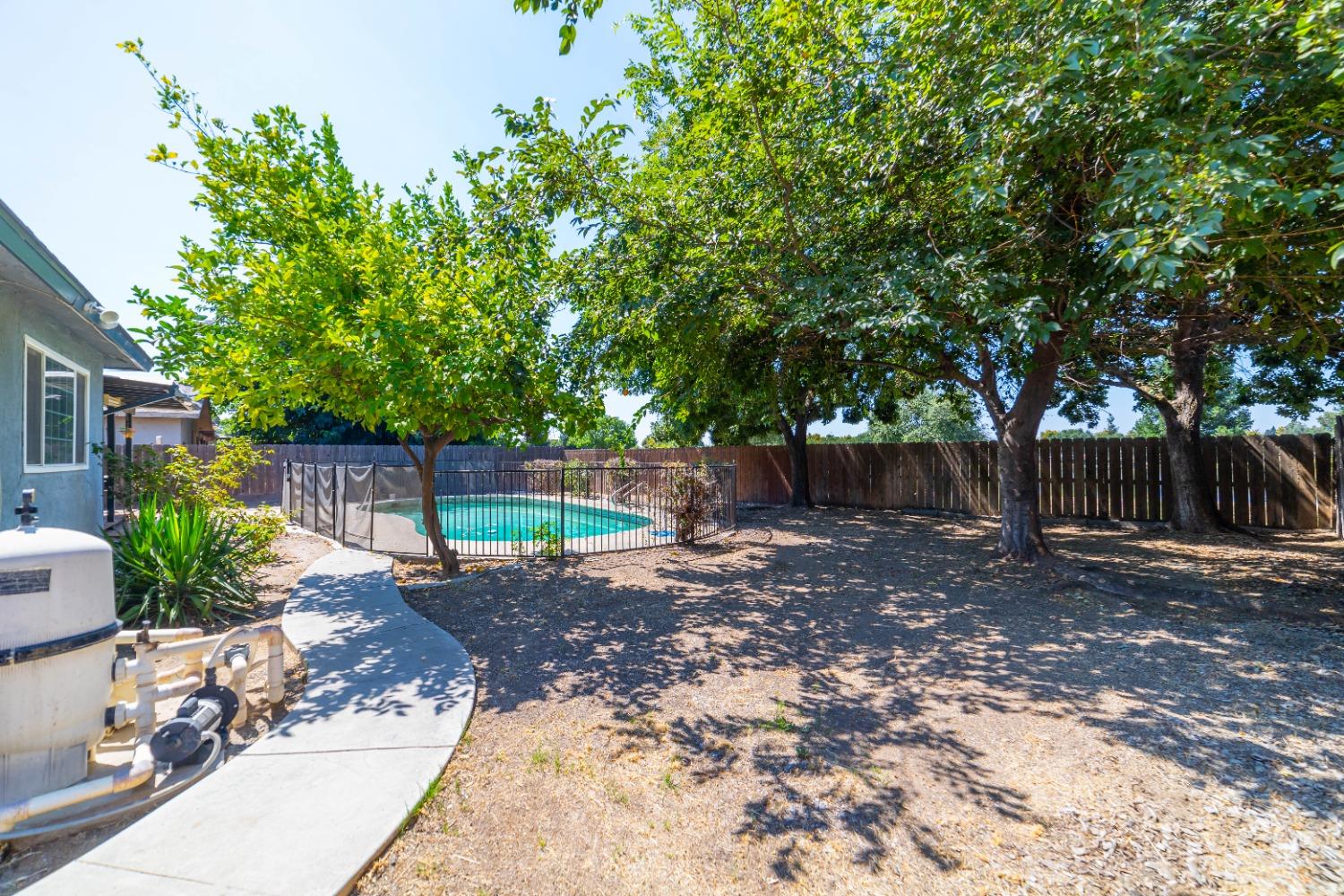 142 West Swift Avenue Clovis, CA 93612 - Photo 16 of 24 a view of a backyard with a trees and entertaining space