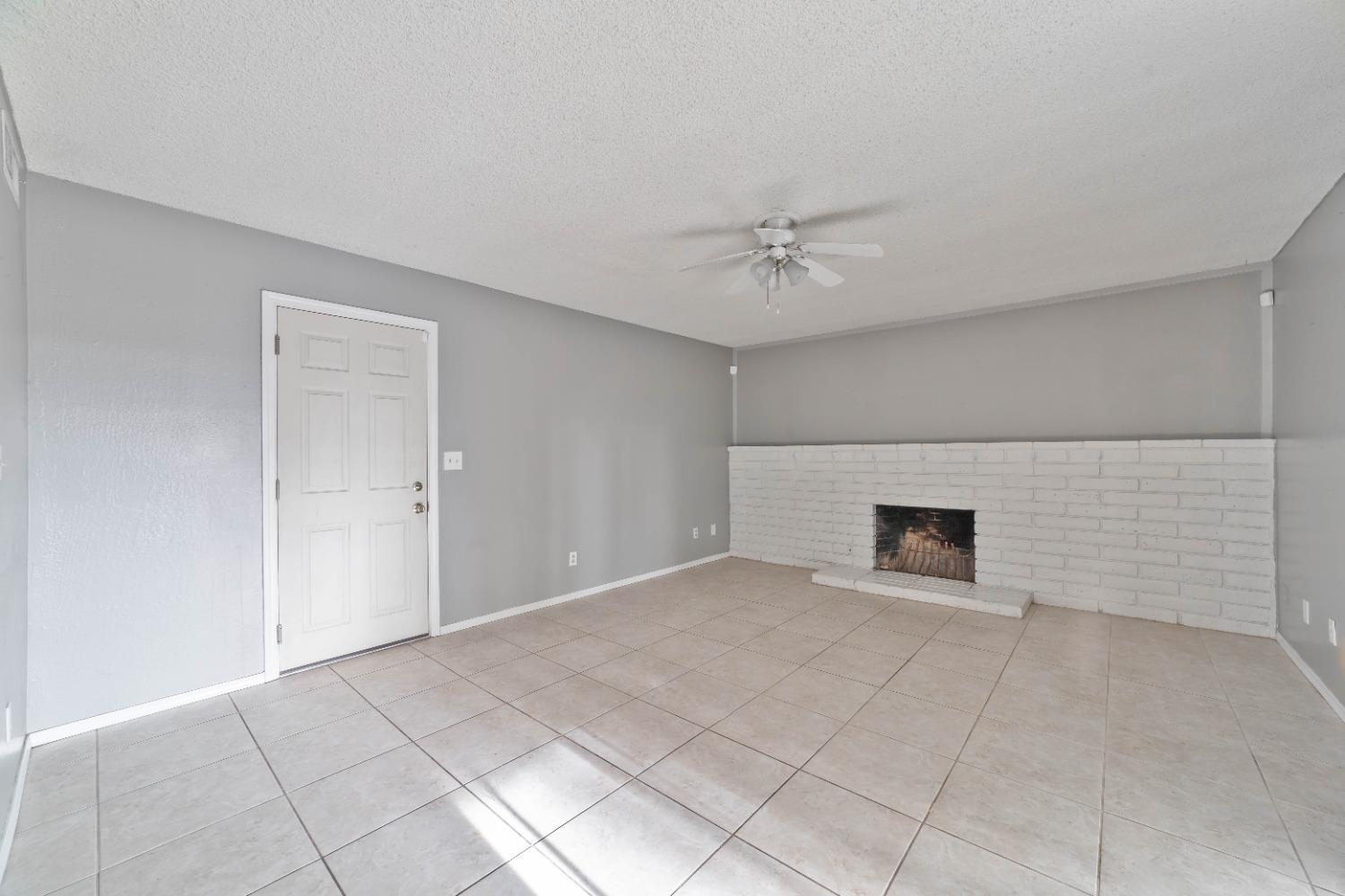 142 West Swift Avenue Clovis, CA 93612 - Photo 3 of 24 a view of an empty room with a fireplace
