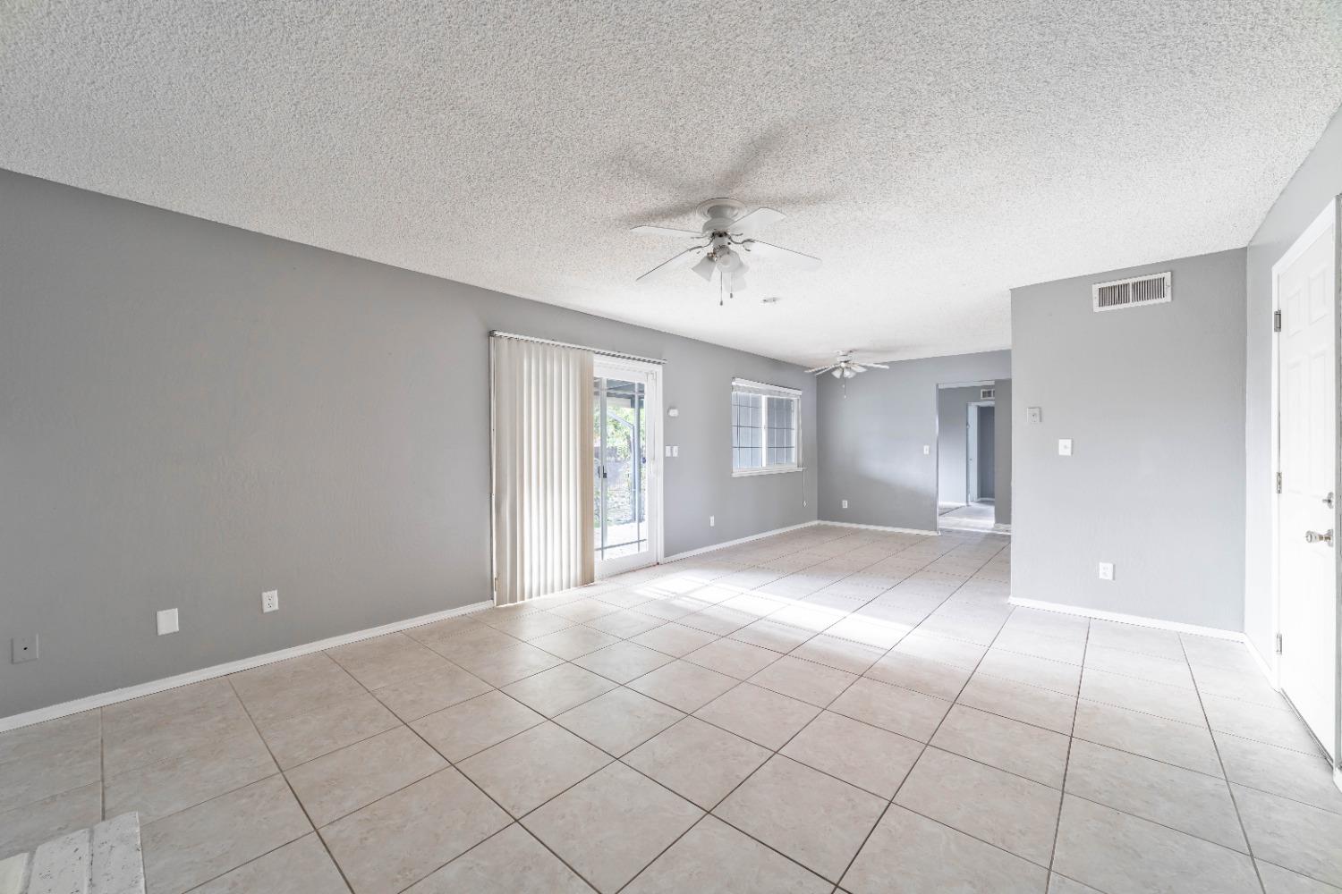 142 West Swift Avenue Clovis, CA 93612 - Photo 4 of 24 a view of an empty room with a window