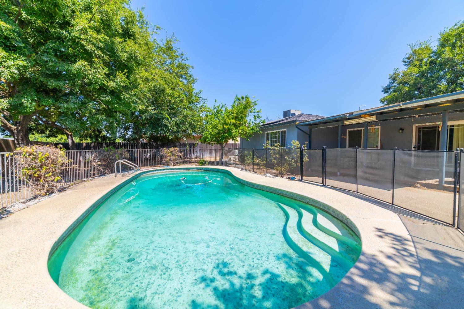 142 West Swift Avenue Clovis, CA 93612 - Photo 6 of 24 a view of a swimming pool with a patio