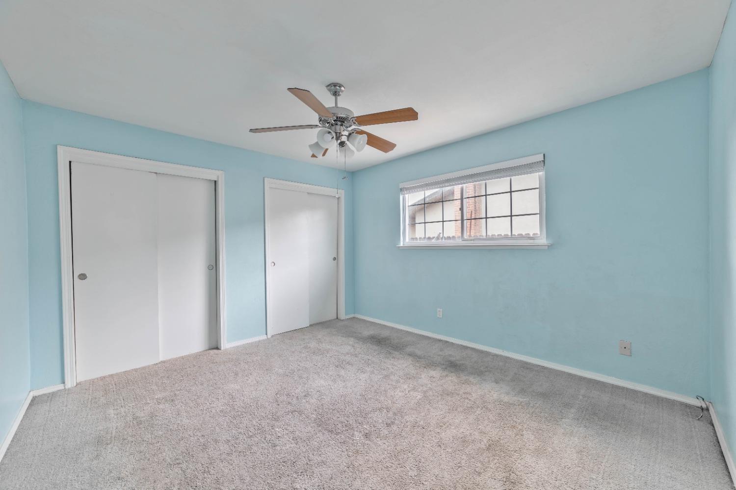 142 West Swift Avenue Clovis, CA 93612 - Photo 8 of 24 a view of a big room with windows and chandelier fan