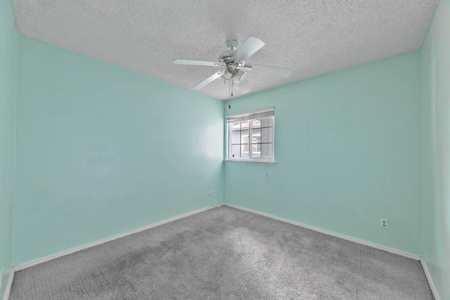 142 West Swift Avenue Clovis, CA 93612 - Photo 9 of 24 an empty room with a window and a fan