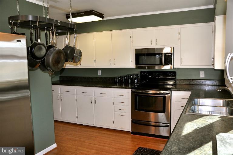 779 Masons Beach Road Deale, MD 20751 - Photo 12 of 14 a kitchen with stainless steel appliances granite countertop a stove a sink and a microwave