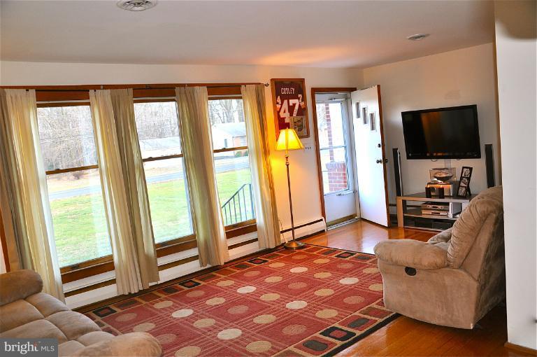 779 Masons Beach Road Deale, MD 20751 - Photo 5 of 14 a living room with furniture and a flat screen tv