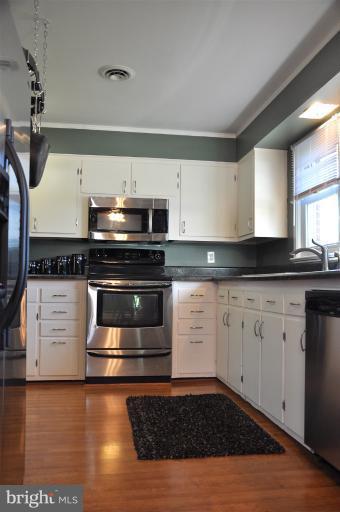 779 Masons Beach Road Deale, MD 20751 - Photo 9 of 14 a kitchen with granite countertop a stove and a microwave