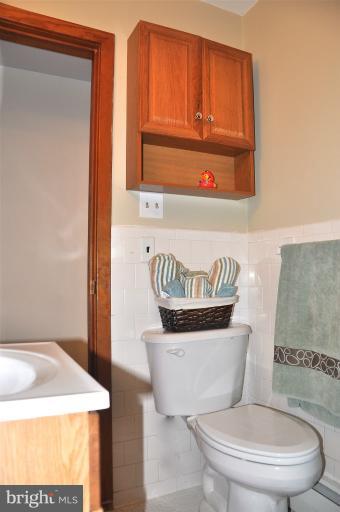 779 Masons Beach Road Deale, MD 20751 - Photo 10 of 14 a bathroom with a toilet a sink and a window