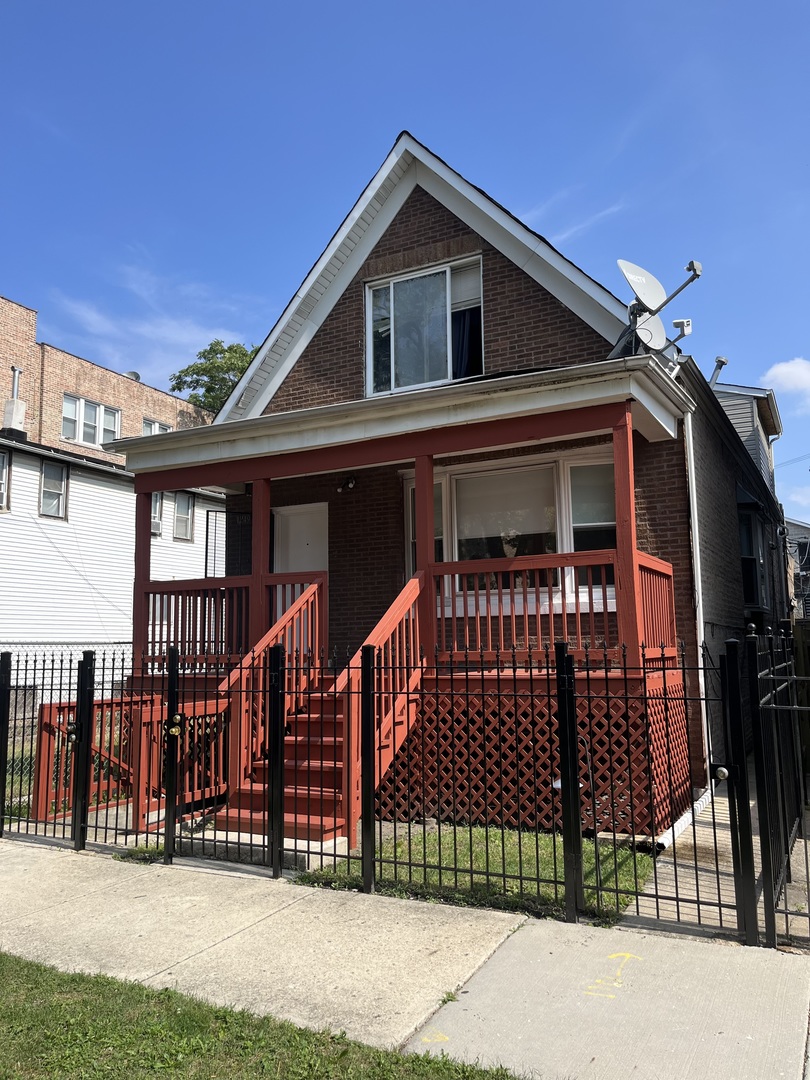 1249 South Kolin Avenue, Unit 1 Chicago, IL 60623 - Photo 1 of 20 a front view of a house with iron fence