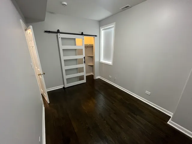 a view of walk in closet with empty racks