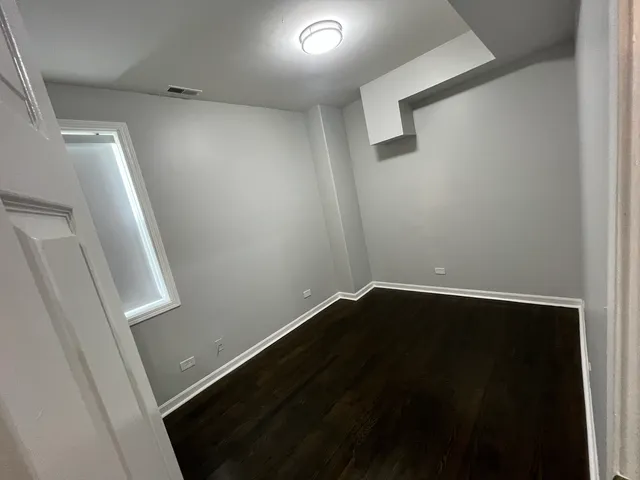 an empty room with wooden floor