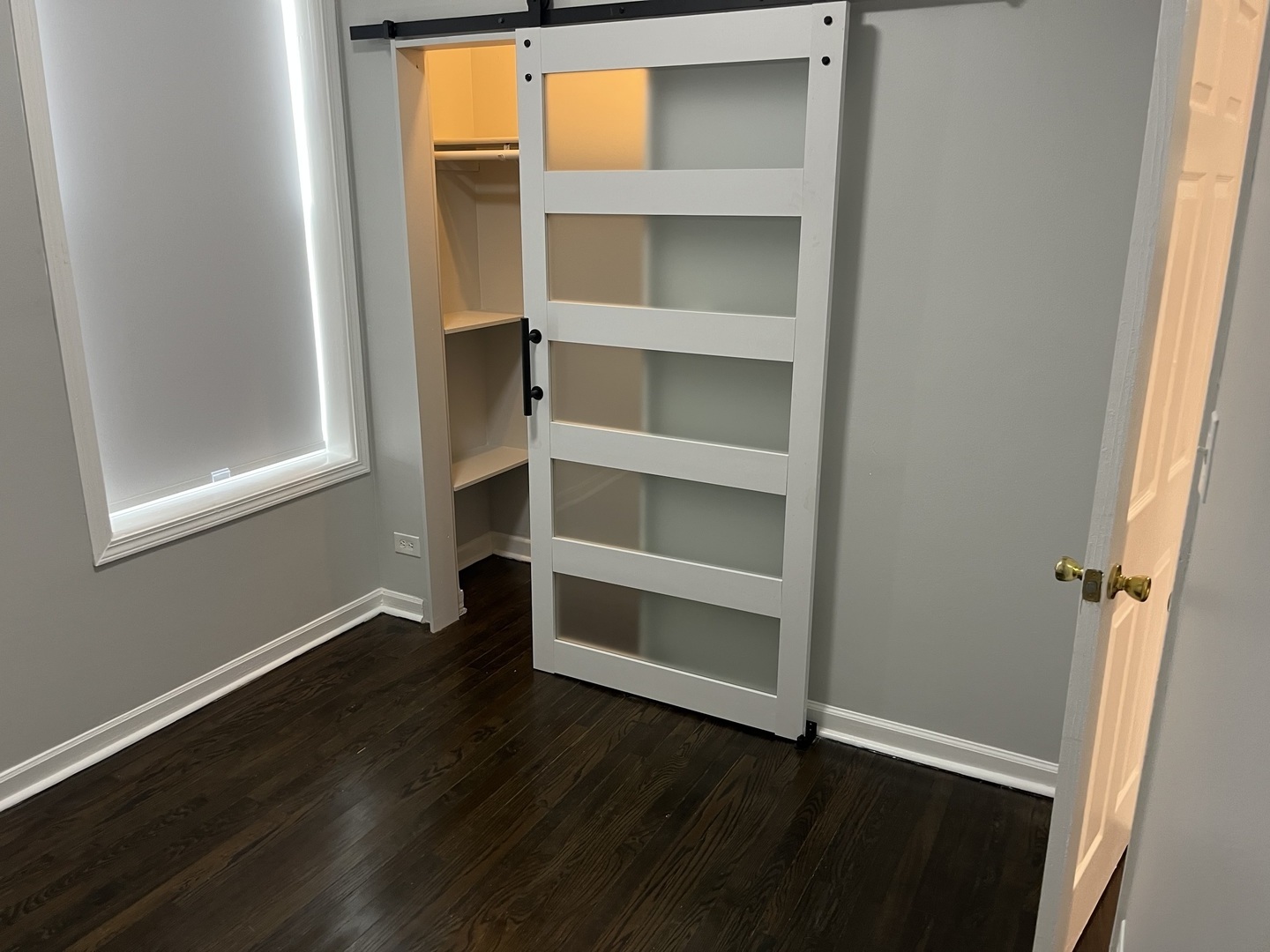 1249 South Kolin Avenue, Unit 1 Chicago, IL 60623 - Photo 17 of 20 a view of an empty room with a window and wooden floor