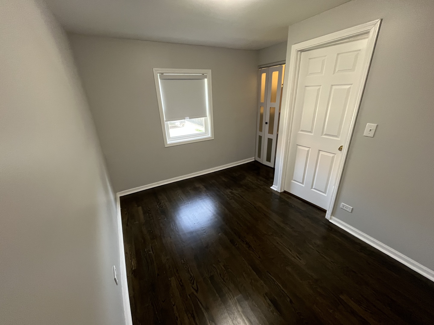 1249 South Kolin Avenue, Unit 1 Chicago, IL 60623 - Photo 19 of 20 an empty room with wooden floor and windows