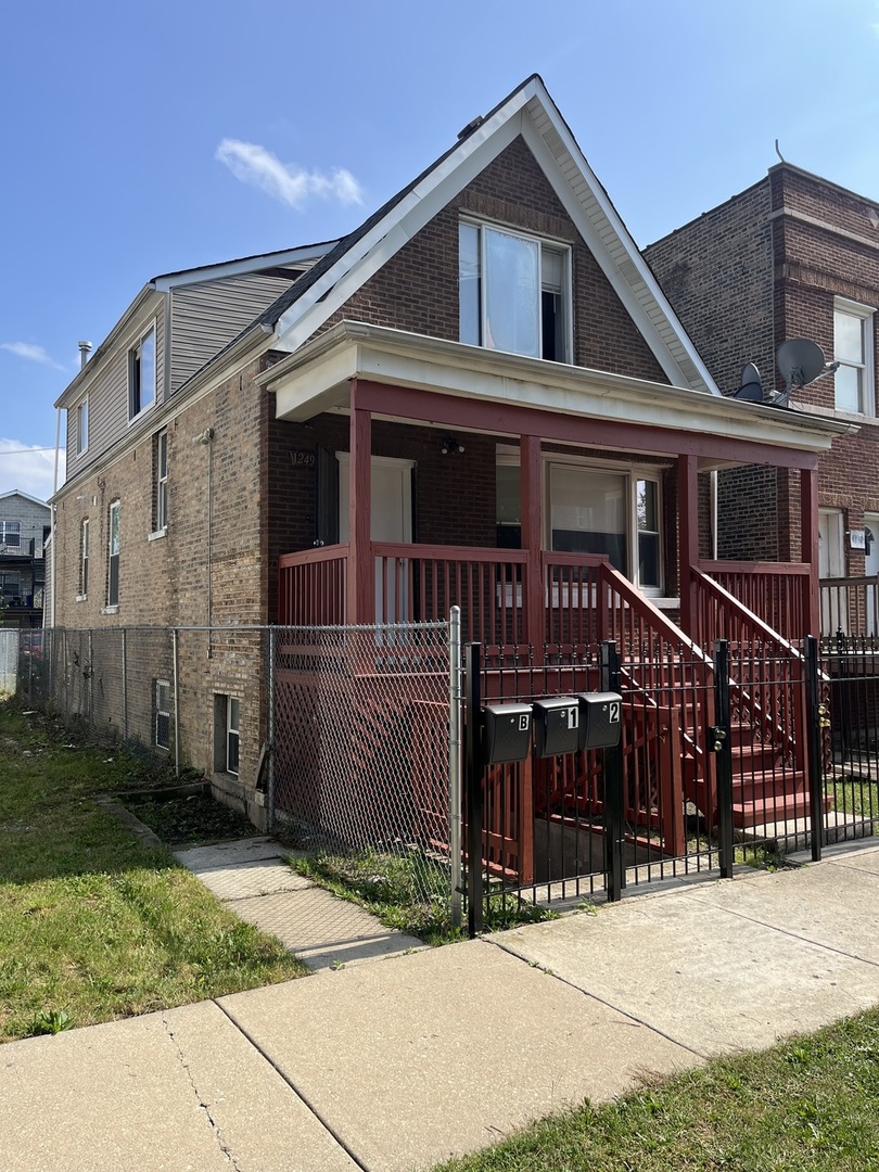 1249 South Kolin Avenue, Unit 1 Chicago, IL 60623 - Photo 2 of 20 a front view of a house with yard