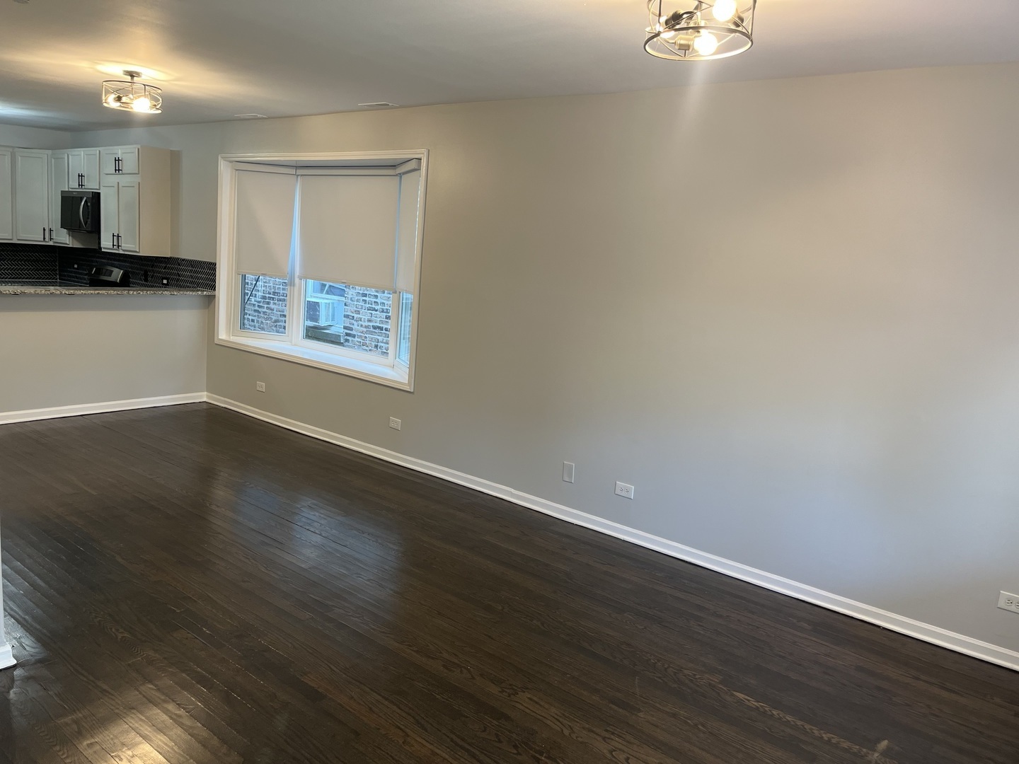 1249 South Kolin Avenue, Unit 1 Chicago, IL 60623 - Photo 5 of 20 a view of a room with wooden floor and kitchen space