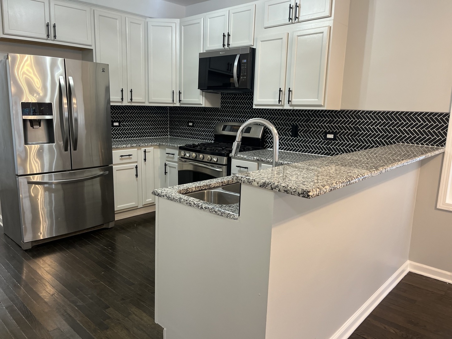 1249 South Kolin Avenue, Unit 1 Chicago, IL 60623 - Photo 7 of 20 a kitchen with stainless steel appliances granite countertop a refrigerator sink and stove