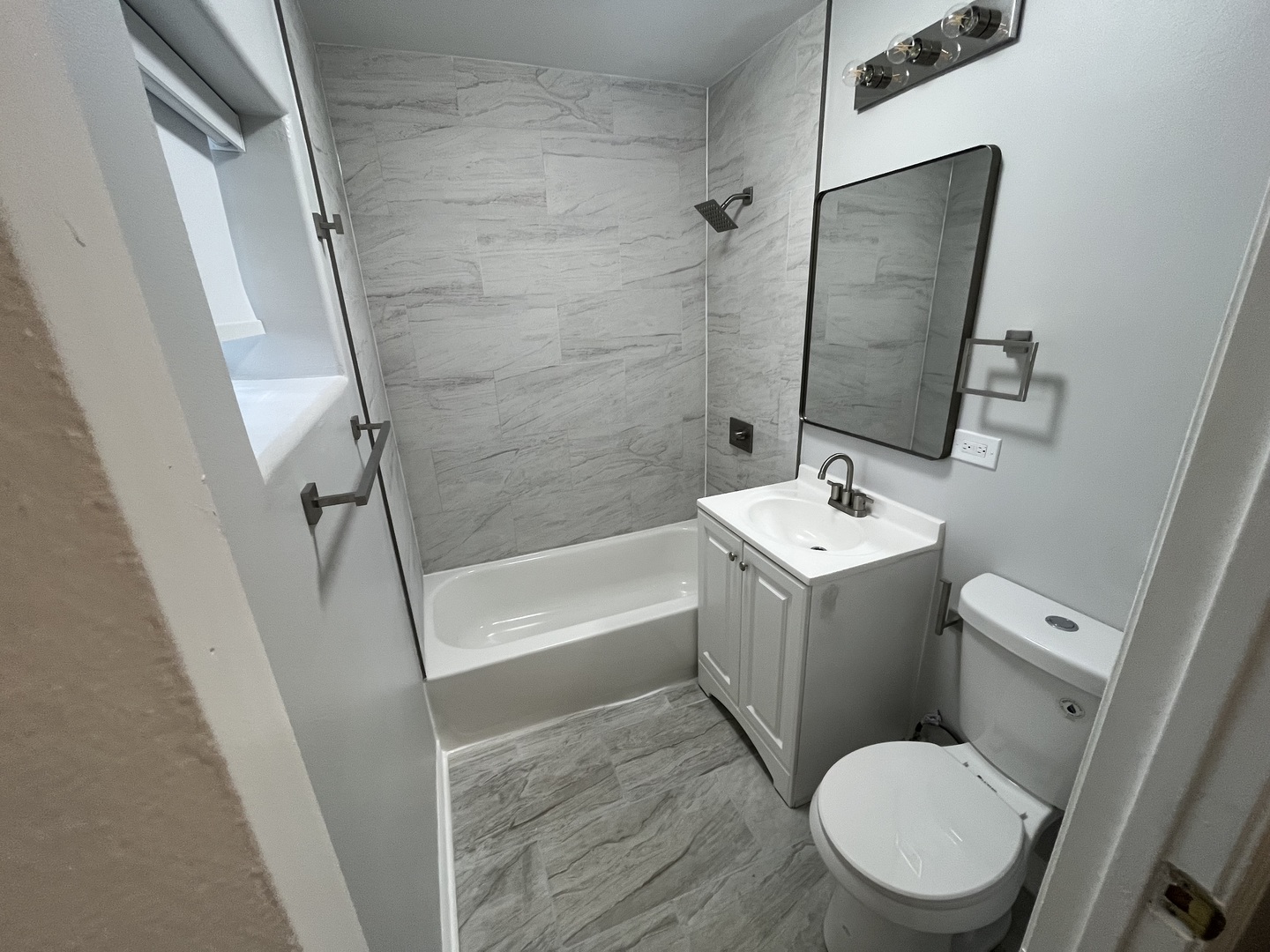 1249 South Kolin Avenue, Unit 1 Chicago, IL 60623 - Photo 10 of 20 a white toilet sitting next to a bath tub