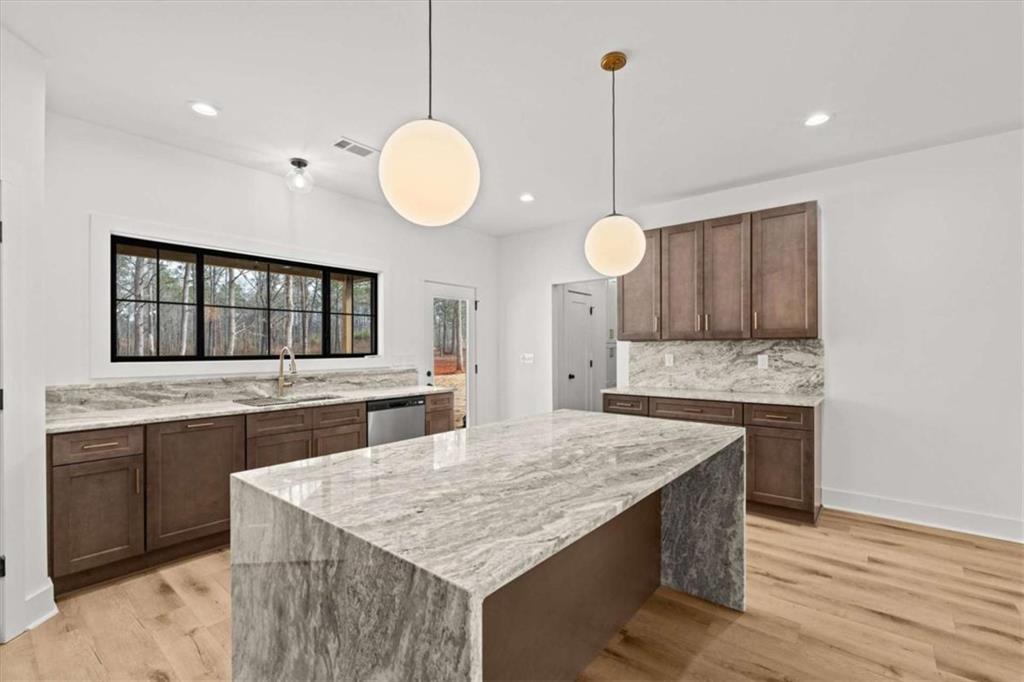 415 Lively Road Waco, GA 30182 - Photo 15 of 49 a kitchen with a stove and a wooden floor