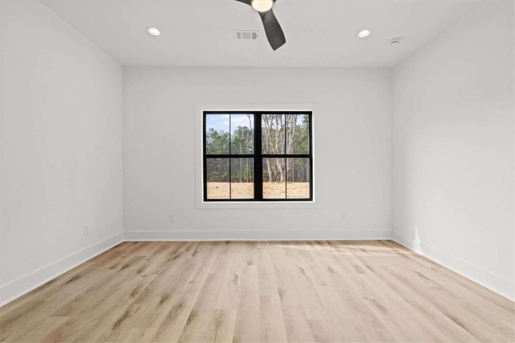 415 Lively Road Waco, GA 30182 - Photo 19 of 49 an empty room with wooden floor cabinet and windows