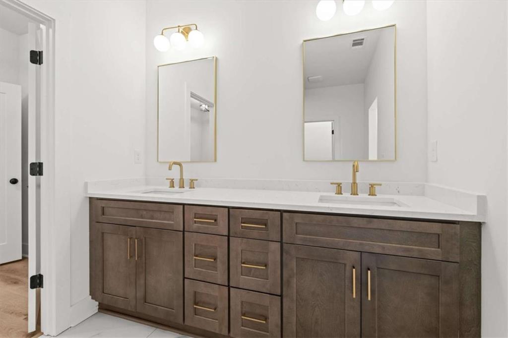 415 Lively Road Waco, GA 30182 - Photo 23 of 49 a bathroom with a double vanity sink and mirror