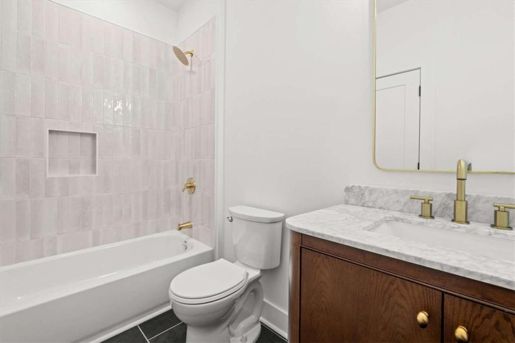 415 Lively Road Waco, GA 30182 - Photo 34 of 49 a bathroom with a sink a toilet and a bathtub