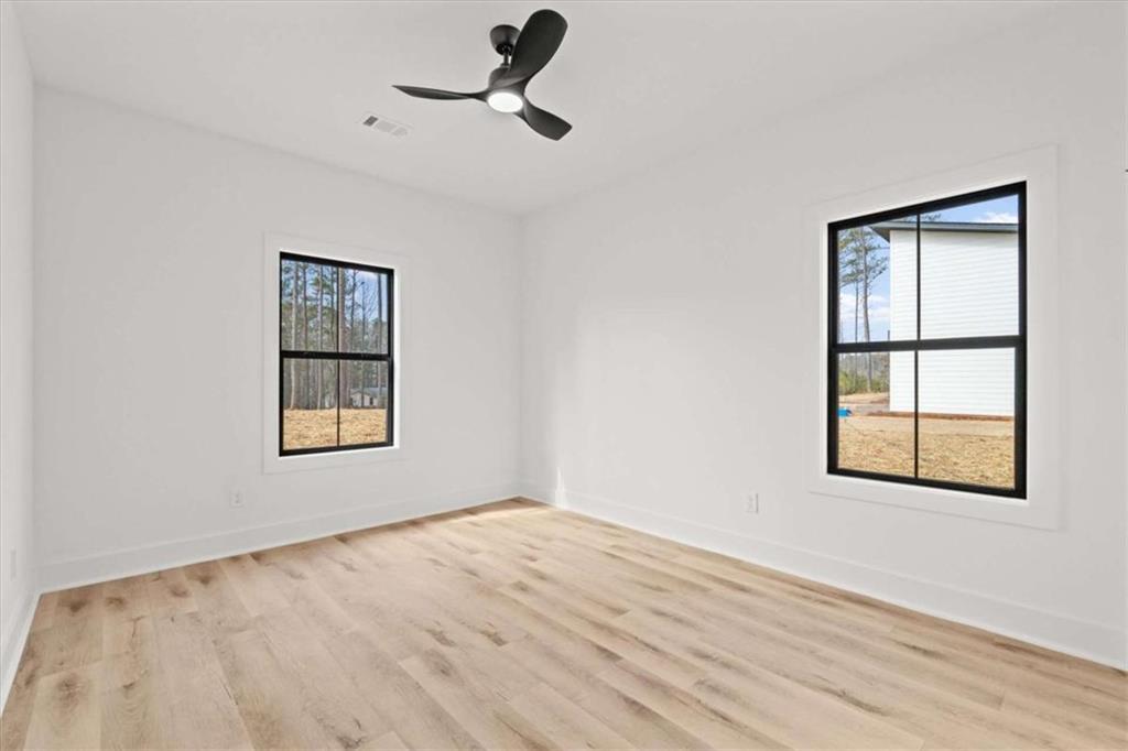 415 Lively Road Waco, GA 30182 - Photo 37 of 49 a view of an empty room with a window and wooden floor