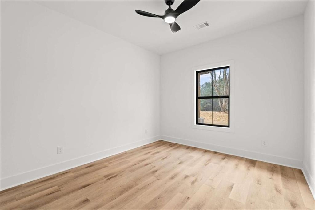 415 Lively Road Waco, GA 30182 - Photo 40 of 49 an empty room with a window and a ceiling fan
