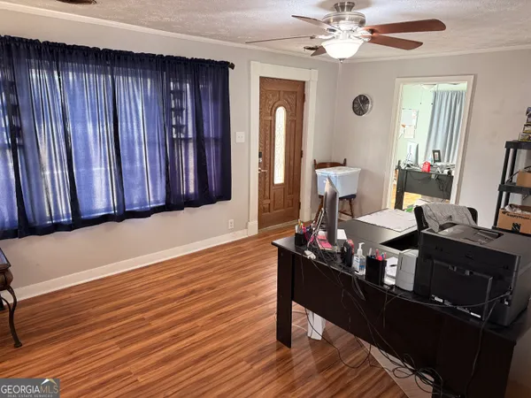 a living room with furniture and wooden floor