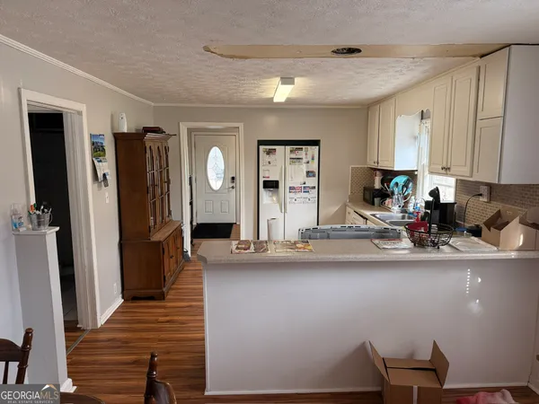 a kitchen with refrigerator and sink