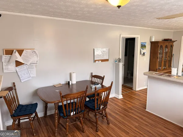 a view of a dining room with furniture and wooden floor