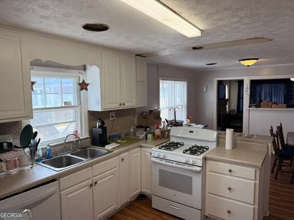 a kitchen with a sink stove and cabinets