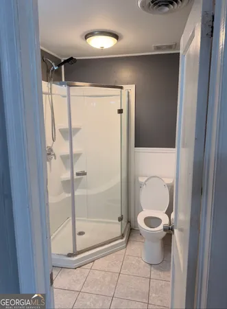 a bathroom with a shower and a toilet