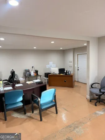 a living room with furniture a rug and a piano