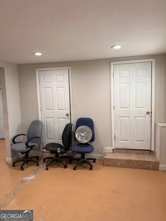 a room with gym equipment and wooden floor