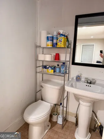 a white toilet sitting next to a bathroom sink