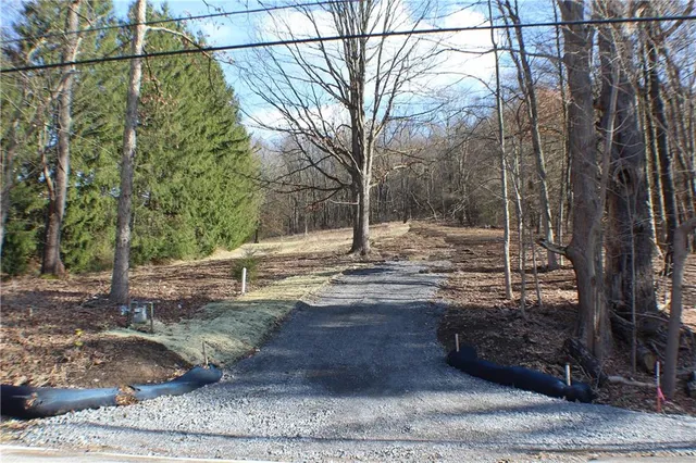 a view of a yard with wooden fence
