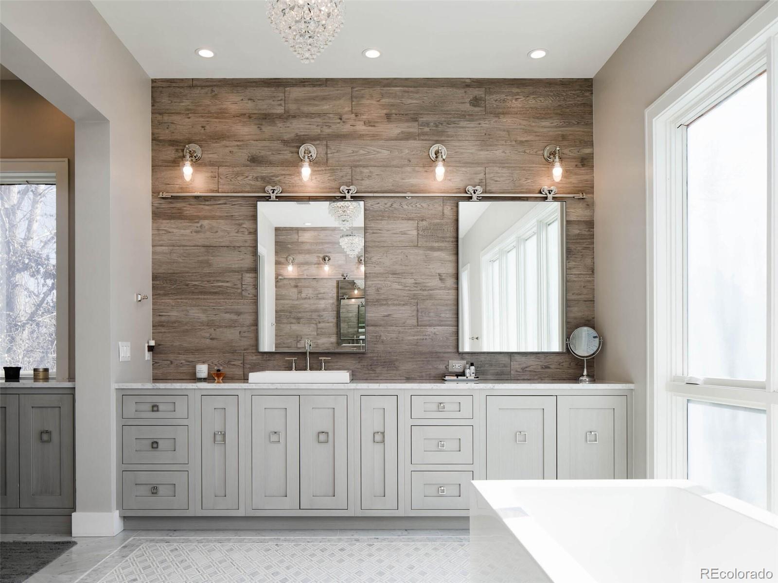 2550 Cherryridge Road Englewood, CO 80113 - Photo 22 of 40 a bathroom with a granite countertop sink a mirror a vanity and a bathtub