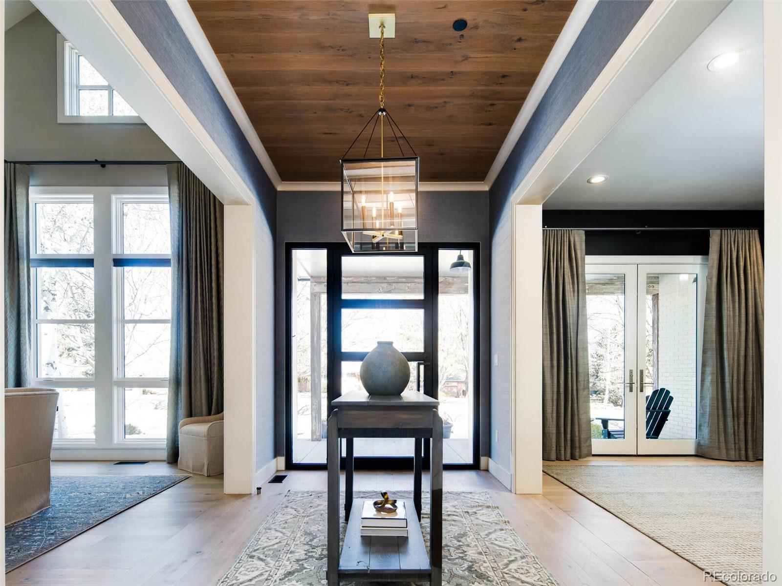 2550 Cherryridge Road Englewood, CO 80113 - Photo 3 of 40 a living room with furniture a window and a chandelier