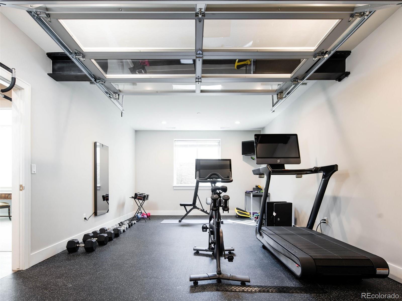 2550 Cherryridge Road Englewood, CO 80113 - Photo 36 of 40 a room with gym equipment and a flat screen tv