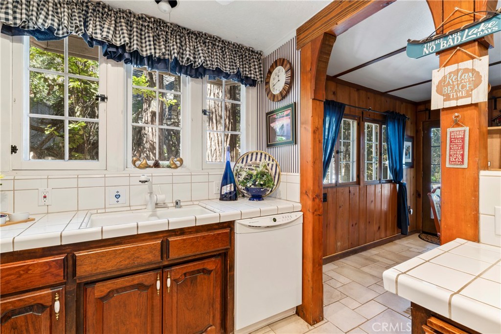 197 Rocky Point Road Lake Arrowhead, CA 92352 - Photo 12 of 35 a kitchen with a sink and a large window