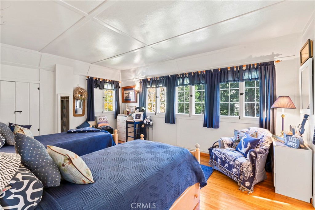 197 Rocky Point Road Lake Arrowhead, CA 92352 - Photo 20 of 35 a bedroom with furniture and large windows