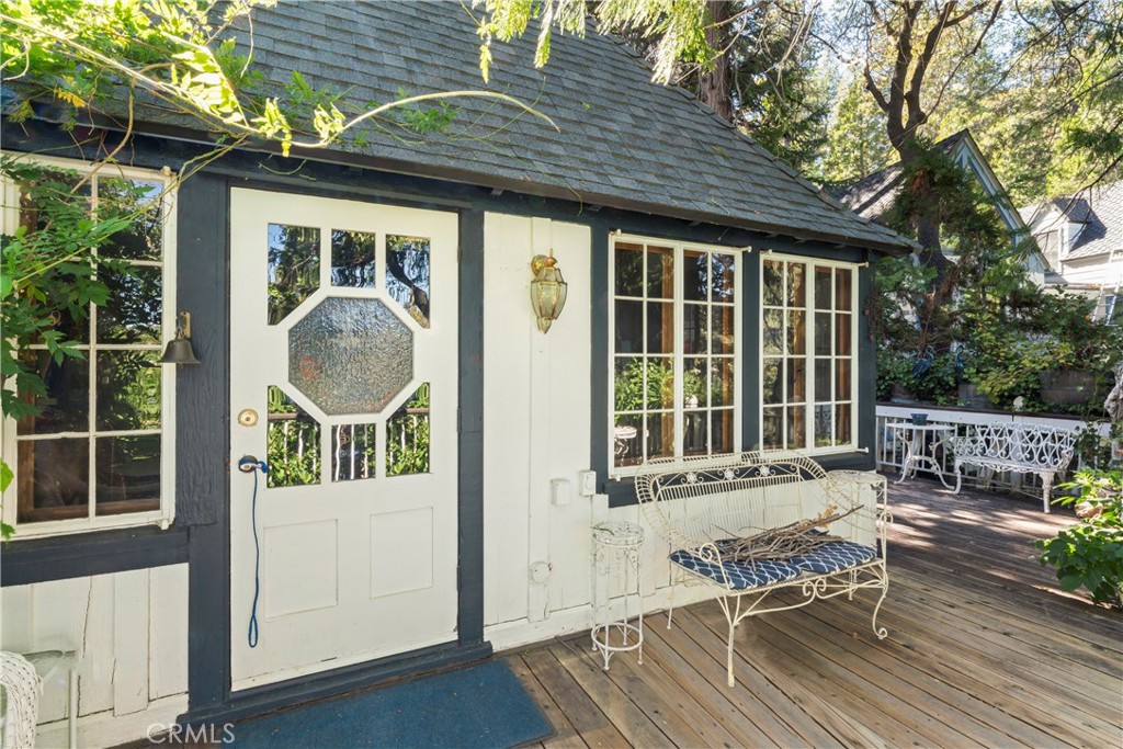 197 Rocky Point Road Lake Arrowhead, CA 92352 - Photo 28 of 35 a view of deck with table and chairs and wooden floor
