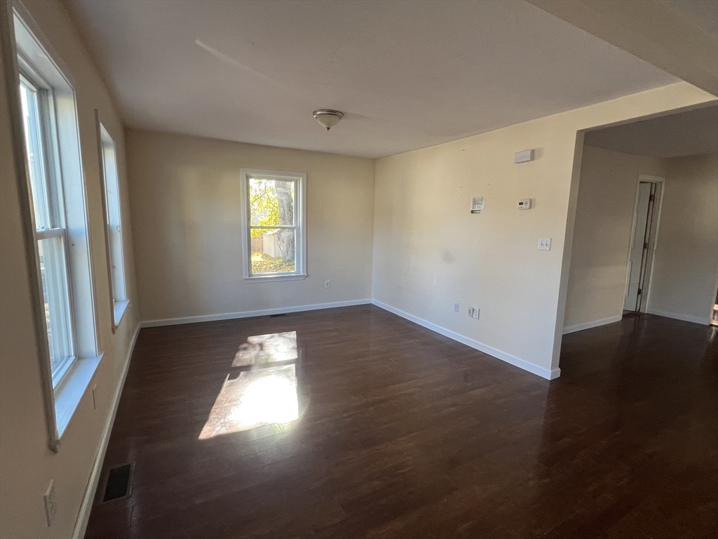 22 Forest Avenue Clinton, MA 01510 - Photo 3 of 13 an empty room with wooden floor and windows